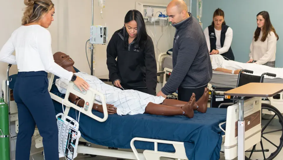 A group of physical therapy students in the simulation lab